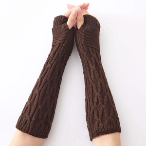 Detailed close-up of dark brown knit arm warmer with classic cable pattern and ribbed cuffs