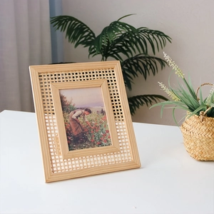 Minimalist solid wood picture frame with natural rattan weave insert and floral illustration