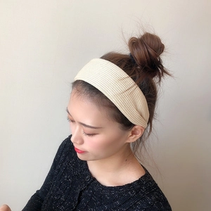 Close-up of beige knitted headband texture on model during stylish autumn season