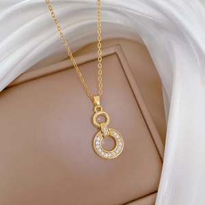 Detail of gold double circle interlocking necklace with shimmering crystal pavé on velvet box