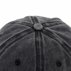 Macro view of washed cotton fabric top with embroidered eyelets on a baseball cap