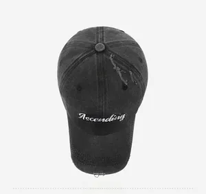 Top down view of a distressed charcoal denim baseball cap with white Ascending embroidery