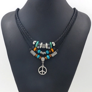 Detail of bohemian multilayer cowhide necklace with turquoise beads and peace sign pendant