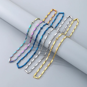 Detail view of hip-hop bamboo chains in rainbow, blue, silver, and gold finishes