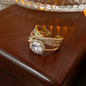 Luxurious gold layered open ring with oval cubic zirconia and micro-pave accents