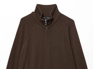 Detail of soft dark brown knit sweater showing half-zip collar and shoulder stitching