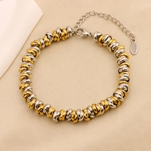 Detailed macro view of two-tone gold and silver stainless steel beaded hip-hop bracelet