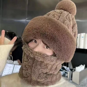 Detailed view of the brown fleece winter hat and neck warmer set worn by a model