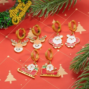 Christmas earrings set featuring reindeer and Santa Claus charms with red background
