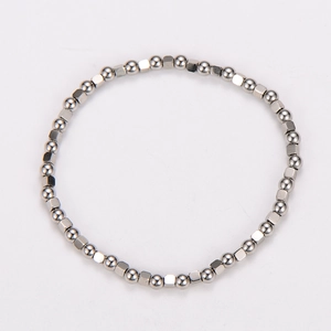 Macro shot of silver stainless steel bracelet featuring alternating beads and cubes