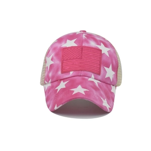 Detail of pink tie-dye baseball cap featuring white stars and US flag patch