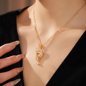 Close-up of 18k gold plated star horse necklace with sparkling cubic zirconia on a model