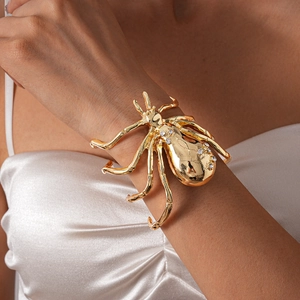 Detailed macro shot of a gold spider cuff bracelet with sparkling crystal rhinestones