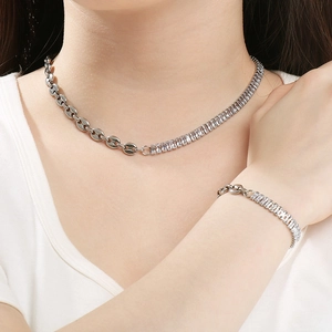 Detail view of silver chain jewelry set with OT buckle and emerald cut zircon stones