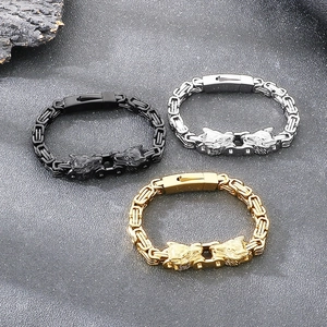 Detail of vintage wolf head bracelets in black, silver and gold stainless steel finish