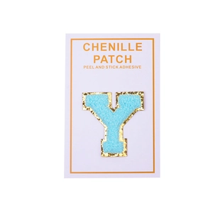 Detail of blue chenille letter Y patch with gold glitter edge and peel-and-stick backing