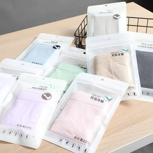 Macro view of assorted pastel cooling arm sleeves in retail zip packaging on wood table