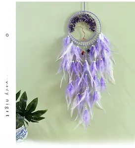 Macro shot of purple crystal tree of life design with soft feathers on dream catcher