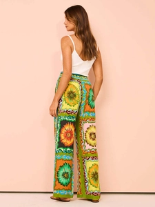 Detail of high-waisted wide-leg trousers with vibrant floral and geometric prints