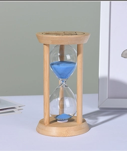 Detail of wooden hourglass top with engraved time text and blue sand texture inside