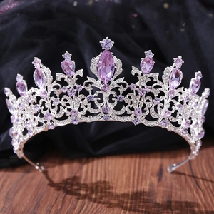 Detailed view of silver wedding crown featuring purple pear-shaped crystals and rhinestones