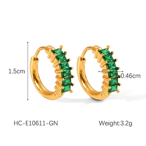 Macro view of gold-plated hoop earrings with green zircon insets and 1.5cm dimension