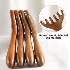 Macro detail of sandalwood massage comb showing smooth natural wood grain and 5-tooth design
