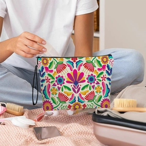 Floral Mexican style cosmetic bag with black zipper and wristlet strap for travel