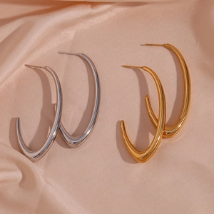 Minimalist V-shaped stainless steel hoop earrings in gold and silver finish on silk fabric