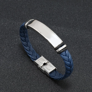 Close-up of a navy blue braided leather bracelet with a polished silver metal plate