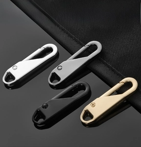 Macro detail of metal zipper pull replacements in four colors with spring hook design