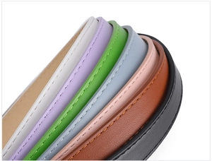 Macro shot of colorful leather belts with oval buckles and fine stitching details