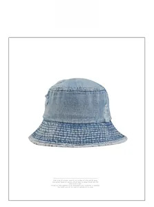 Close-up of distressed light blue denim bucket hat with raw edges and vintage torn details