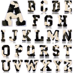 Macro detail of camouflage chenille alphabet letter patches with soft towel embroidery texture