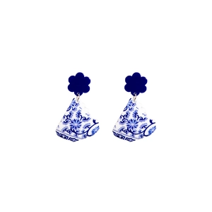 Detailed view of blue and white porcelain style flower earrings with acrylic patterns