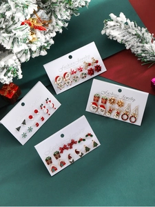 Close-up of assorted Christmas stud earrings with holiday patterns on display cards