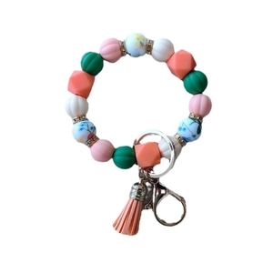 Colorful silicone pumpkin bead bracelet keychain with orange tassel and floral accents