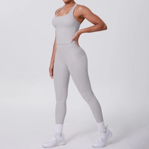 Detail of light gray yoga set featuring racerback tank top and leggings with side pockets