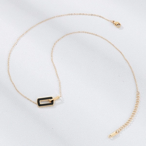 Detail of rose gold stainless steel necklace with square pendant and lobster clasp