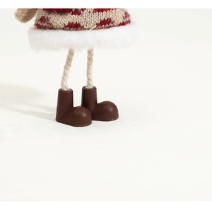 Detailed macro view of Christmas doll knit fabric with faux fur trim and brown boots