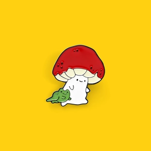 Cartoon enamel pin featuring a cute ghost wearing a red mushroom hat with a green frog