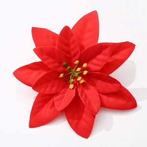 Detail of red velvet poinsettia petals with yellow-green stamens for Xmas decor