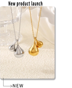 Macro view of gold and silver teardrop pendants on cross chains with a mirror-polished finish