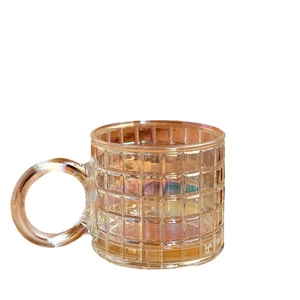 Minimalist iridescent glass mug with grid texture and round handle on white background