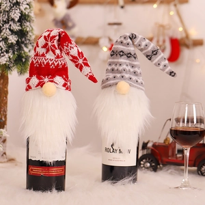 Christmas gnome wine bottle covers with knitted hats and white beards in festive decor