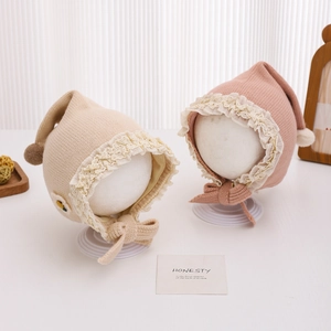 Warm baby lace knit hat with plush balls and chin straps in beige and pink colors