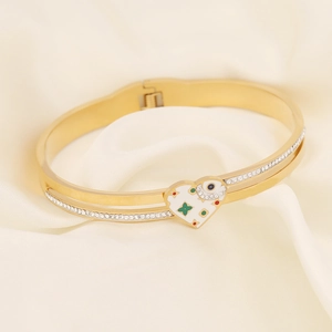 Detail of gold heart pendant with green clover inlay and double-row zircon bangles