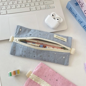 Close-up of star pattern canvas pencil cases in blue and pink with woven hand straps