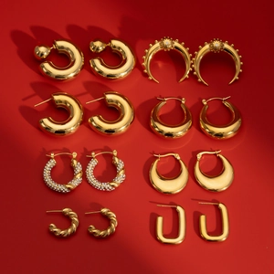 Golden stainless steel earring set with zircon accents on a vibrant red background