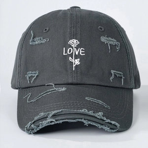 Detail of distressed dark gray cotton baseball cap with white rose and LOVE embroidery